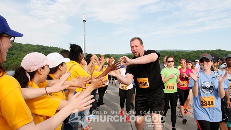 Church of God Volunteers Cheering on at Walkway Marathon
